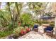 Beautiful paver patio with comfortable seating and lush tropical landscaping for backyard relaxation at 921 Tartan Dr # 31, Venice, FL 34293