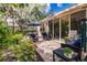 Inviting outdoor patio with comfortable seating and lush tropical landscaping at 921 Tartan Dr # 31, Venice, FL 34293