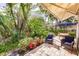 Paver patio with seating and tropical landscaping; an outdoor oasis at 921 Tartan Dr # 31, Venice, FL 34293