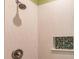 Close-up of shower featuring decorative backsplash and hexagon tile in-lay at 921 Tartan Dr # 31, Venice, FL 34293