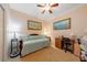 Inviting bedroom featuring artwork, a daybed, and a desk with a chair at 9839 Nostalgia Pl, Englewood, FL 34223