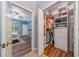 Walk-in closet with custom shelving and hanging space, adjoining Primary bedroom at 9839 Nostalgia Pl, Englewood, FL 34223