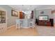 An open-concept eat-in kitchen with bar stool seating, pendant lights, and an adjacent living area at 9839 Nostalgia Pl, Englewood, FL 34223