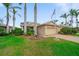 Well-kept home exterior with lush green lawn, showcasing the property's appealing curb appeal at 9839 Nostalgia Pl, Englewood, FL 34223
