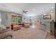 Open concept living room with a large patterned rug, ceiling fan, and an adjoining dining area at 9839 Nostalgia Pl, Englewood, FL 34223