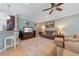 Cozy living room with plush seating, an entertainment center and an adjoining eat in kitchen at 9839 Nostalgia Pl, Englewood, FL 34223