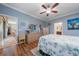 Comfortable main bedroom featuring laminate floors and an ensuite bathroom with a sink and vanity at 9839 Nostalgia Pl, Englewood, FL 34223