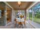 Bright sunroom with floor-to-ceiling windows, dining table, and garden views at 9839 Nostalgia Pl, Englewood, FL 34223