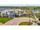 Aerial view of the community clubhouse and pool area surrounded by lush landscaping at 10399 Abaco Falls Dr, Englewood, FL 34223