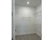 Empty walk-in closet with white walls, tile flooring, and wire shelving installed around the perimeter at 10399 Abaco Falls Dr, Englewood, FL 34223
