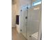 Modern bathroom featuring a glass-enclosed shower with a bench and tiled walls at 10399 Abaco Falls Dr, Englewood, FL 34223