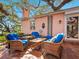 Inviting back patio featuring comfortable seating, offering a peaceful outdoor space with views of the yard at 1049 N Casey Key Rd, Osprey, FL 34229