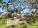 This inviting backyard features stone benches and lush landscaping with a stunning water view at 1049 N Casey Key Rd, Osprey, FL 34229