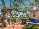 Relaxing backyard patio with wicker seating, shaded by mature trees, and views of the waterfront at 1049 N Casey Key Rd, Osprey, FL 34229