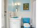 This bathroom features a blue toilet and sink and tiled walls and floors at 1049 N Casey Key Rd, Osprey, FL 34229