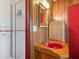Unique bathroom with wood paneling, a standup shower and a red sink at 1049 N Casey Key Rd, Osprey, FL 34229