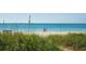 Scenic beach view with lush grasses and sandy shores at 1049 N Casey Key Rd, Osprey, FL 34229