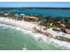 Stunning aerial view of a beachfront estate with turquoise waters and a sandy beach at 1049 N Casey Key Rd, Osprey, FL 34229