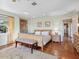 Cozy bedroom featuring a king-sized bed, area rug, and bedside tables with lamps at 1049 N Casey Key Rd, Osprey, FL 34229