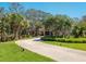 Long driveway leading up to this luxurious house with lush greenery at 1049 N Casey Key Rd, Osprey, FL 34229