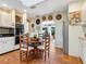 Bright kitchen features white cabinets, stainless steel appliances, terracotta floors, and a round table with seating at 1049 N Casey Key Rd, Osprey, FL 34229