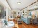 Beautiful living room with terracotta tile, views of the water and fun wall art at 1049 N Casey Key Rd, Osprey, FL 34229