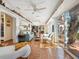 Spacious living room with terracotta tile flooring, large windows, and beautiful waterfront views at 1049 N Casey Key Rd, Osprey, FL 34229