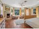 Comfortable main bedroom with fireplace, seating area, and views of the yard through a large window at 1049 N Casey Key Rd, Osprey, FL 34229