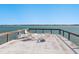 Pier with a concrete patio, railings and seating with a view of the open water at 1049 N Casey Key Rd, Osprey, FL 34229