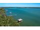 Stunning waterfront view featuring a private dock and pristine turquoise waters under a clear blue sky at 1049 N Casey Key Rd, Osprey, FL 34229