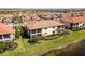 Aerial view of a well-maintained home with screened balconies, overlooking the water at 10797 Tarflower Dr # 202, Venice, FL 34293