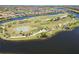 Picturesque aerial view highlighting the community's scenic golf course and surrounding lakes at 10797 Tarflower Dr # 202, Venice, FL 34293
