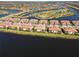 Beautiful aerial view of luxurious waterside homes in a scenic community, and a gorgeous lake at 10797 Tarflower Dr # 202, Venice, FL 34293