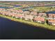 Aerial view showcasing homes with waterfront views in a community near a golf course at 10797 Tarflower Dr # 202, Venice, FL 34293