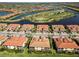 Aerial view featuring beautiful waterfront homes, community lakes, and a scenic golf course at 10797 Tarflower Dr # 202, Venice, FL 34293