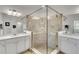 Elegant bathroom featuring glass-enclosed shower, dual vanities, and a bright, airy atmosphere at 10797 Tarflower Dr # 202, Venice, FL 34293