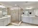 Elegant bathroom featuring glass-enclosed shower, dual vanities, and a bright, airy atmosphere at 10797 Tarflower Dr # 202, Venice, FL 34293