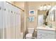 Neutral bathroom includes a shower with shower curtain, a white vanity, and neutral walls at 10797 Tarflower Dr # 202, Venice, FL 34293