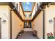 Inviting front entrance with brick pavers, landscaped plants and flowers, and a welcoming doorway with sidelights at 10797 Tarflower Dr # 202, Venice, FL 34293