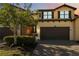 Inviting two-story home featuring a paver driveway, manicured landscaping, and a two-car garage at 10797 Tarflower Dr # 202, Venice, FL 34293