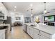 Open concept kitchen with an island, stainless appliances, and seamless flow to the dining and living spaces at 10797 Tarflower Dr # 202, Venice, FL 34293