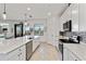 Modern kitchen with island and stainless steel appliances, offering stunning water views at 10797 Tarflower Dr # 202, Venice, FL 34293