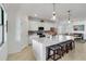 A spacious modern kitchen is equipped with stainless appliances, an island and breakfast bar at 10797 Tarflower Dr # 202, Venice, FL 34293