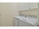 Neat laundry area with appliances and above cabinet storage at 10797 Tarflower Dr # 202, Venice, FL 34293