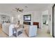 Bright living room featuring a fireplace, flat screen television, and modern furnishings at 10797 Tarflower Dr # 202, Venice, FL 34293