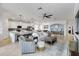 Open-concept living room with neutral tones, modern furnishings, and an adjacent kitchen and dining area at 10797 Tarflower Dr # 202, Venice, FL 34293