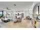 Spacious living room with a ceiling fan, modern furnishings, and an adjacent open kitchen and dining area at 10797 Tarflower Dr # 202, Venice, FL 34293