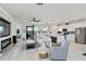 Spacious open-concept living and kitchen area with a modern fireplace and scenic outdoor views at 10797 Tarflower Dr # 202, Venice, FL 34293