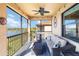 Enjoy serene lake views from this screened patio with comfortable seating at 10797 Tarflower Dr # 202, Venice, FL 34293