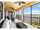 Relax on the screened patio with scenic lake views and multiple seating and dining areas at 10797 Tarflower Dr # 202, Venice, FL 34293